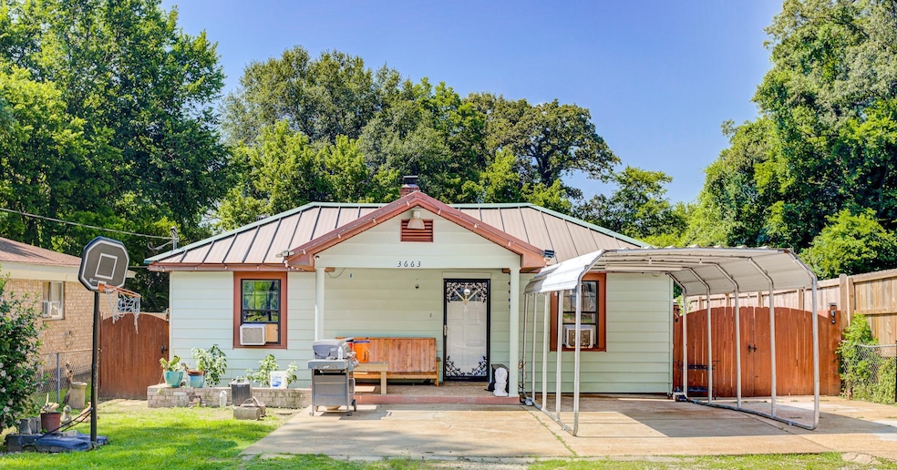 Bungalow-style house with a standing seam roof, a gate, a detached carport, a metal roof, and a chimney