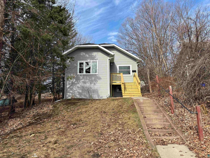 View of side of property featuring stairs