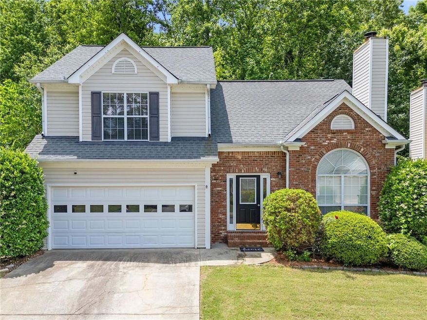 View of front of home with roof with shingles, bri