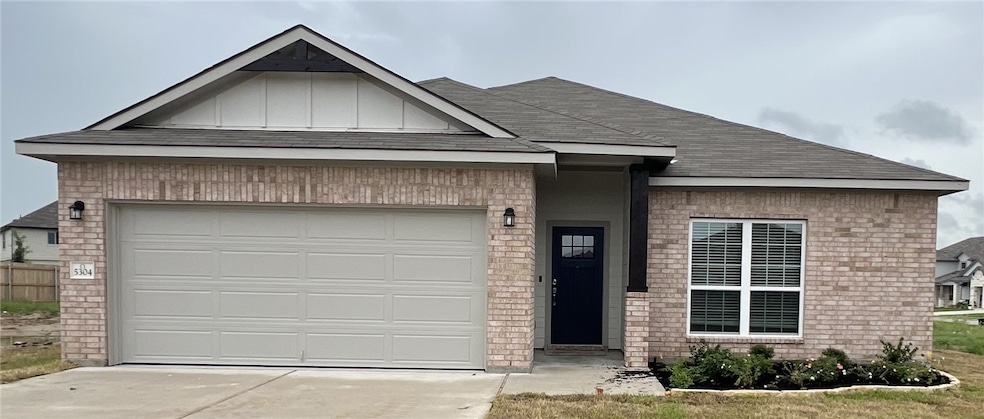 View of front of house featuring brick siding, dri