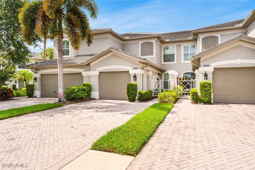 View of property with stucco siding, driveway, and