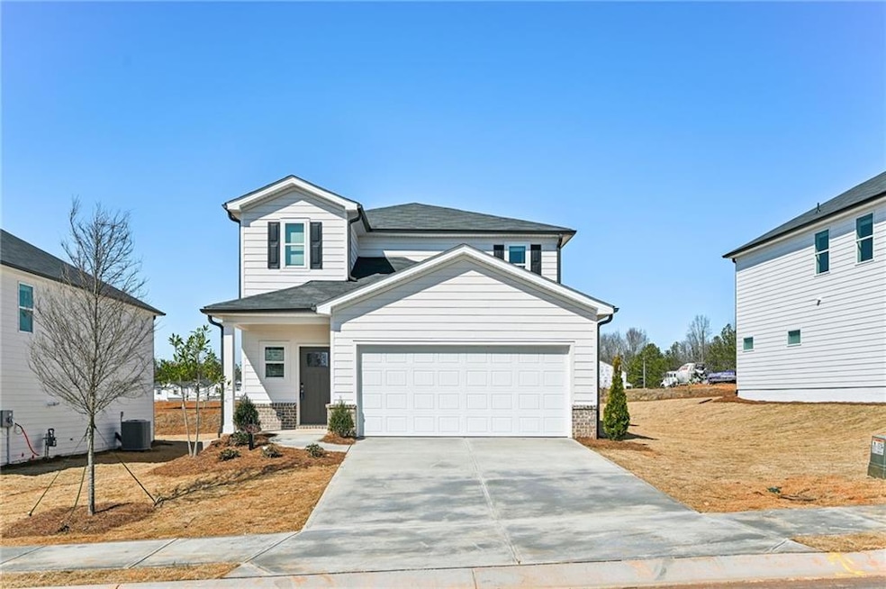 View of front of house featuring concrete driveway
