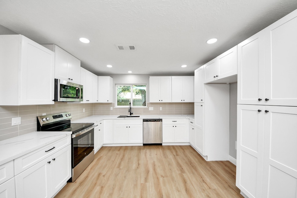 This NEW kitchen features new modern white cabinet