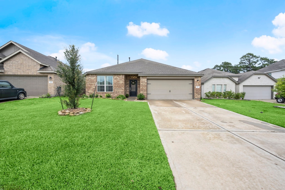 This is a single-story brick home with a two-car g