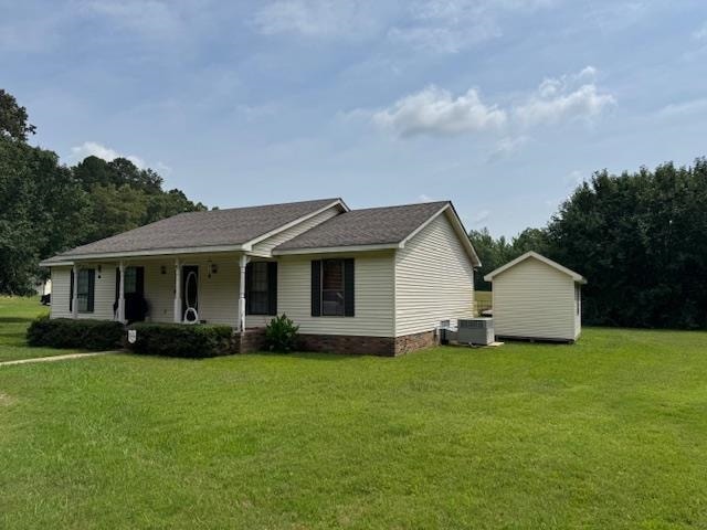View of front facade featuring a front lawn and covered porch