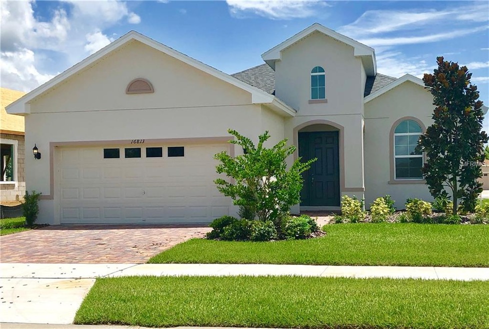Front of Home with Paver Driveway and Beautiful La