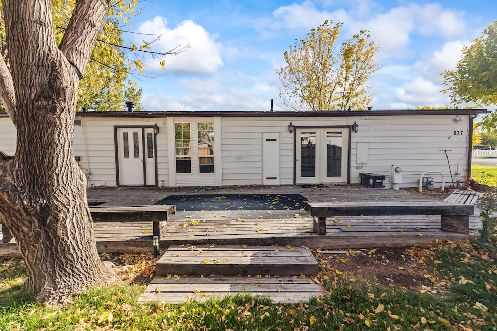 Back of property featuring a deck and french doors