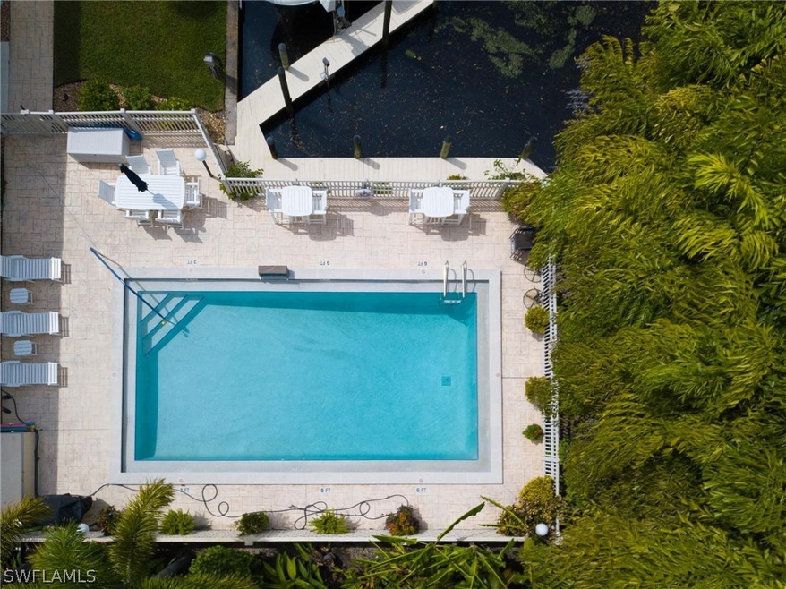 Beautiful pool by the water surrounded by lush veg