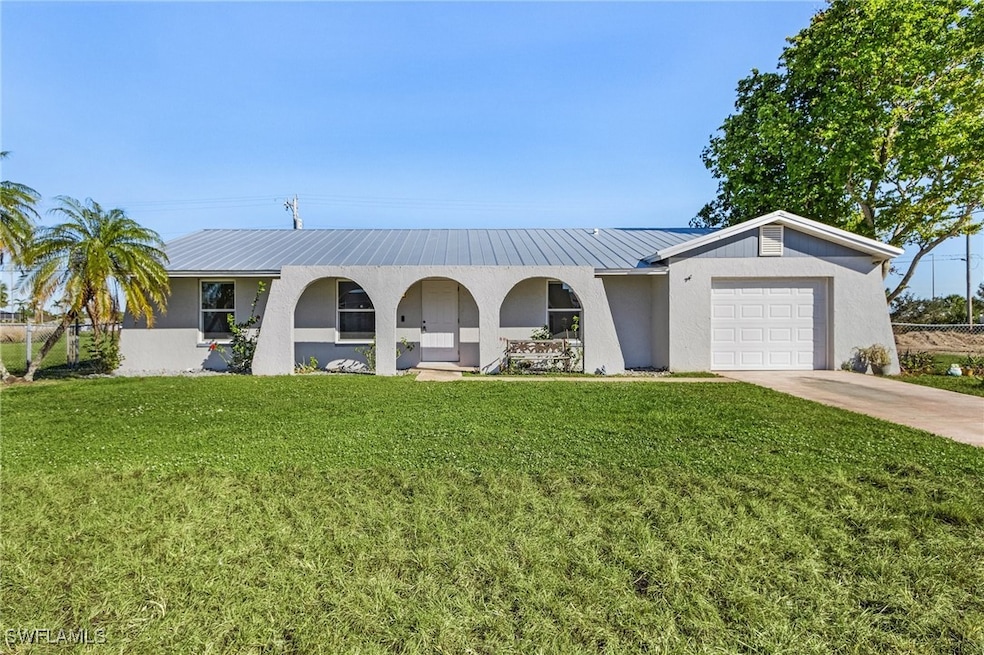 Ranch-style home with a garage and a front lawn