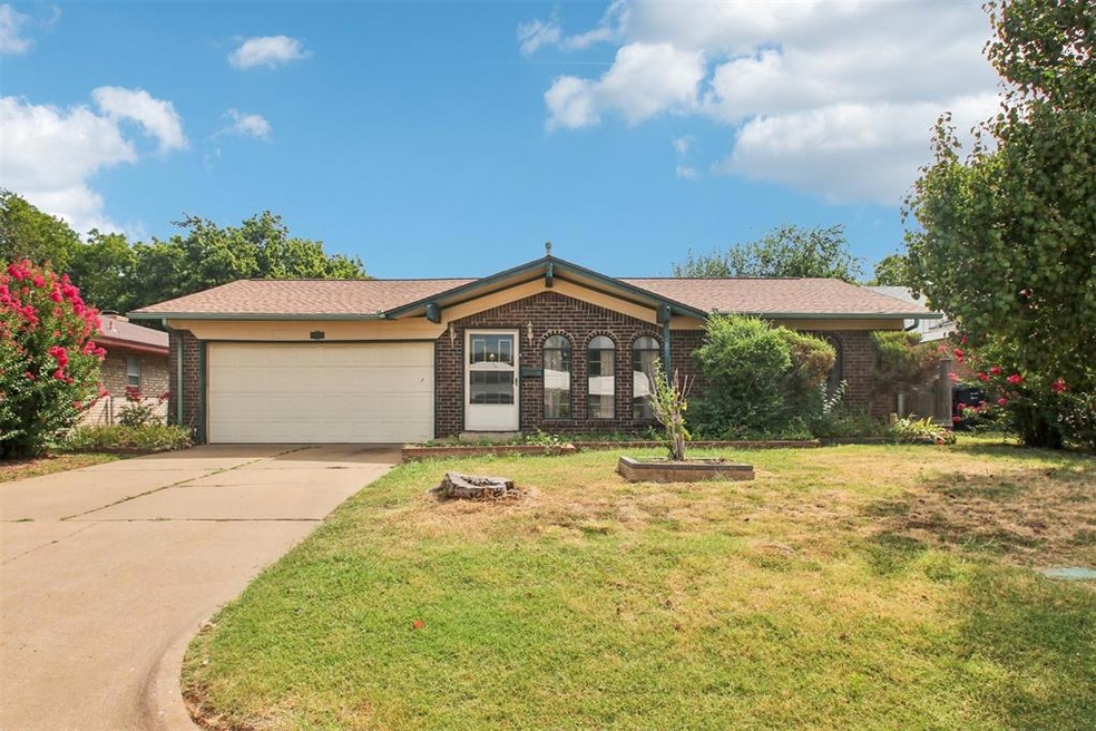 Single story home with a garage and a front yard
