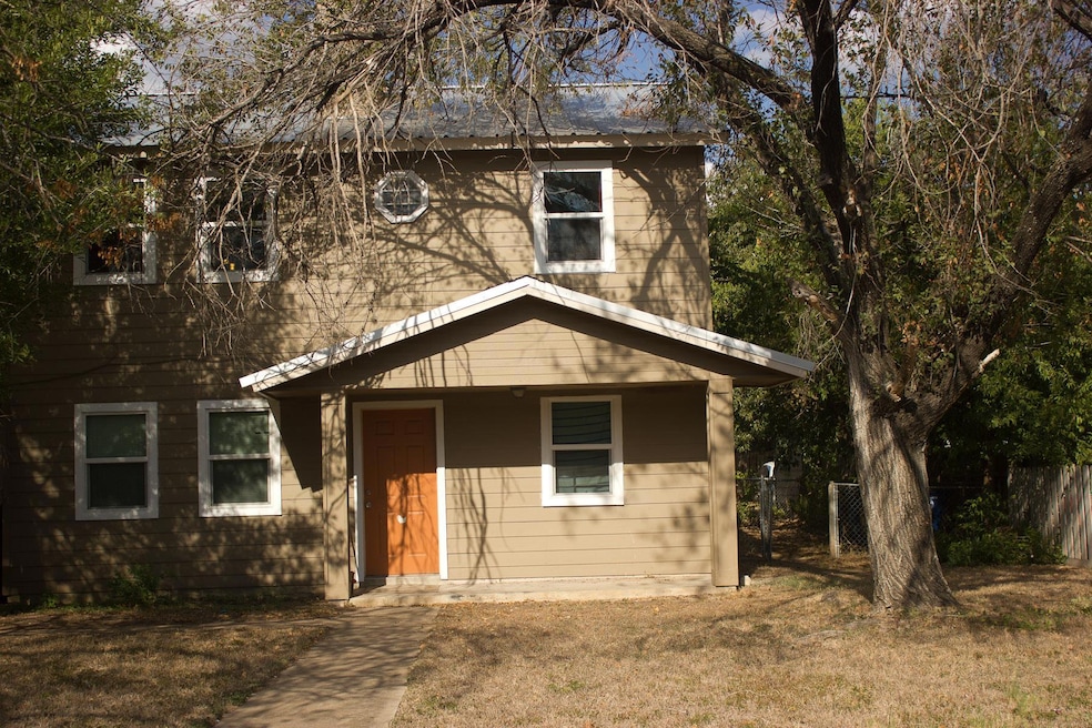 View of front of home with fence and a front yard