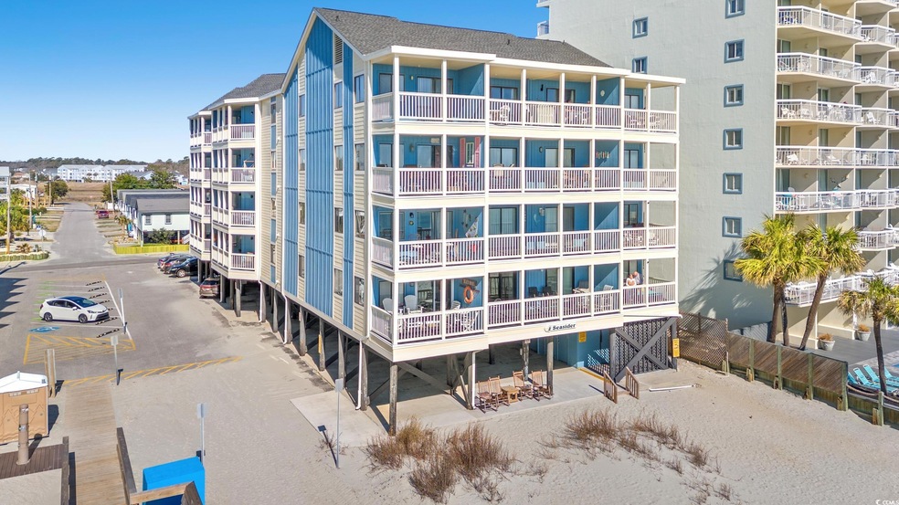 View of building exterior with uncovered parking