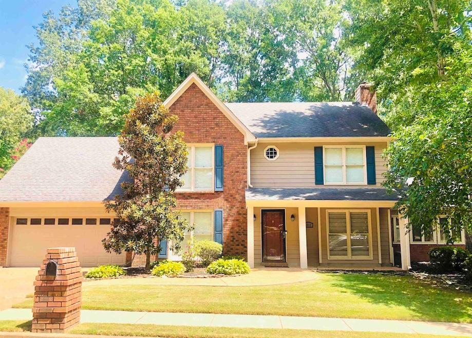 View of front of home with a front lawn, a porch, 
