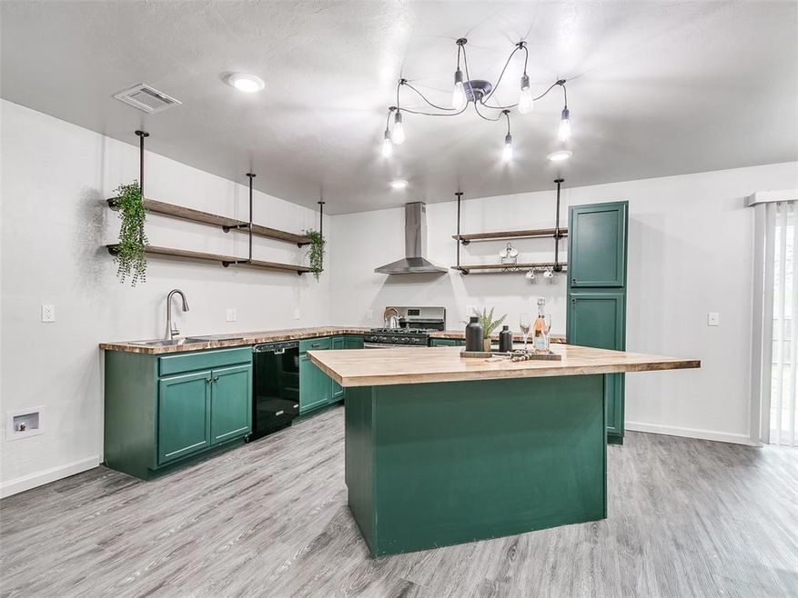 Kitchen with wall chimney exhaust hood, light hard