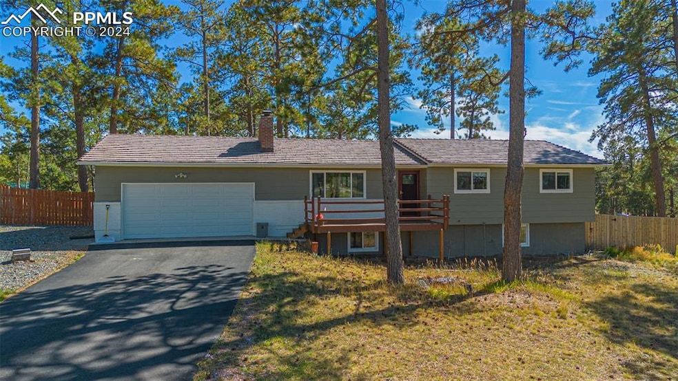 Single story home with a front lawn and a garage