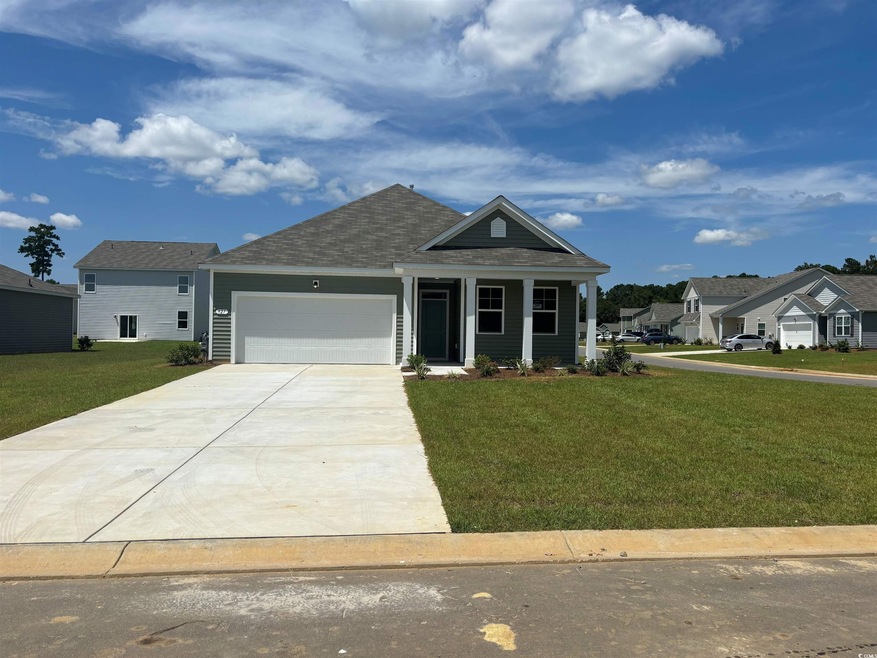 View of front facade with a garage and a front yar