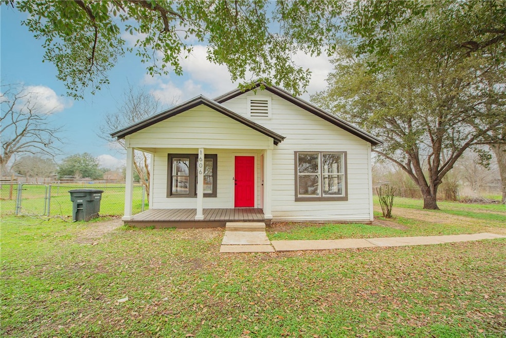 Bungalow-style house featuring covered porch, fenc