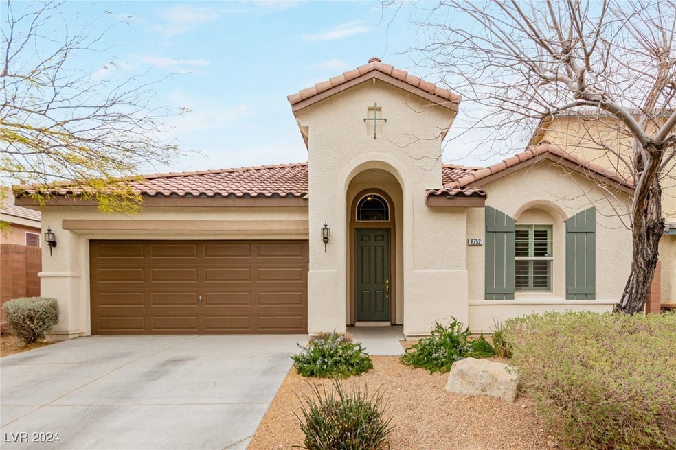 Mediterranean / spanish home with a garage, a tile