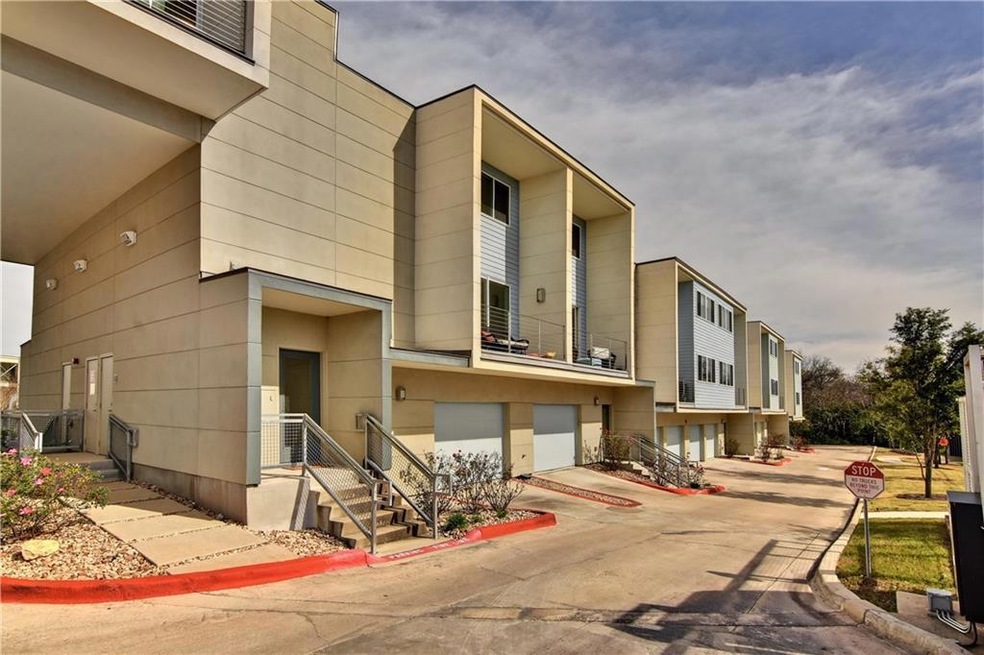 View of building exterior featuring a garage and 
