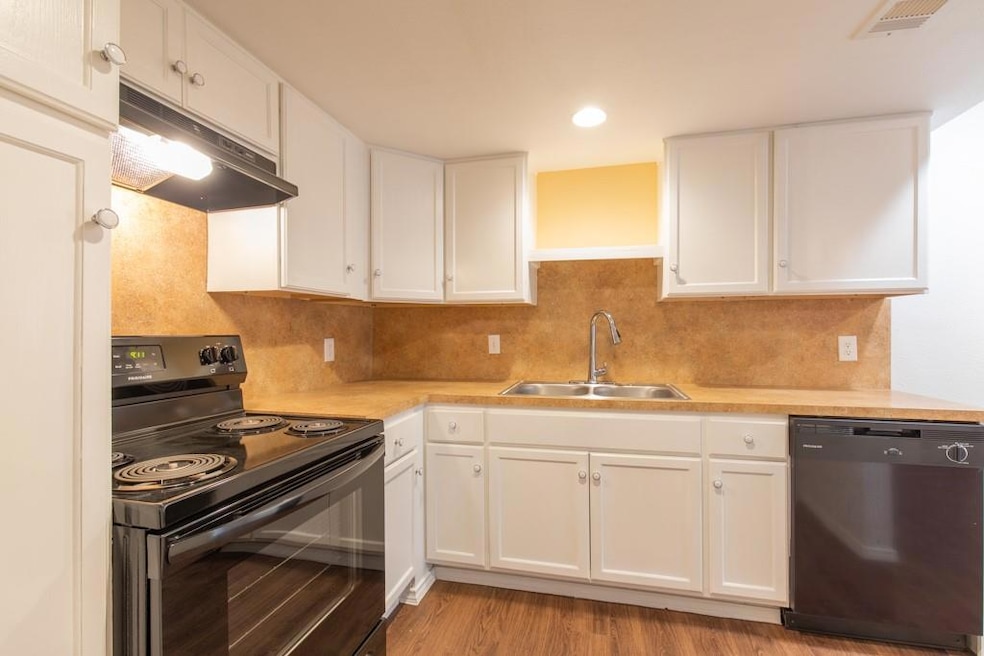 Kitchen featuring black range with electric stove