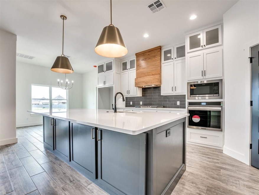 Kitchen with white cabinets, a center island with 