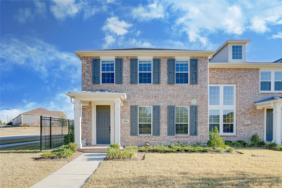 Colonial-style house featuring brick siding