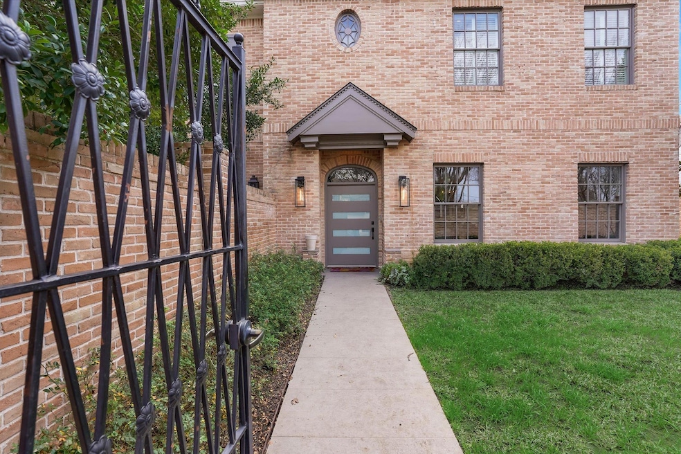 Doorway to property with a yard and brick siding