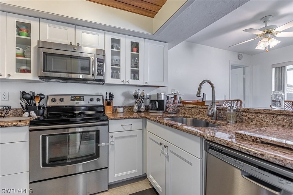 KITCHEN WITH GRANITE COUNTER-TOPS AND ALL STAINLES