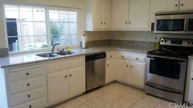 Kitchen with Window Overlooking Private Patio