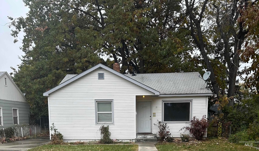 Bungalow featuring a shingled roof and a chimney
