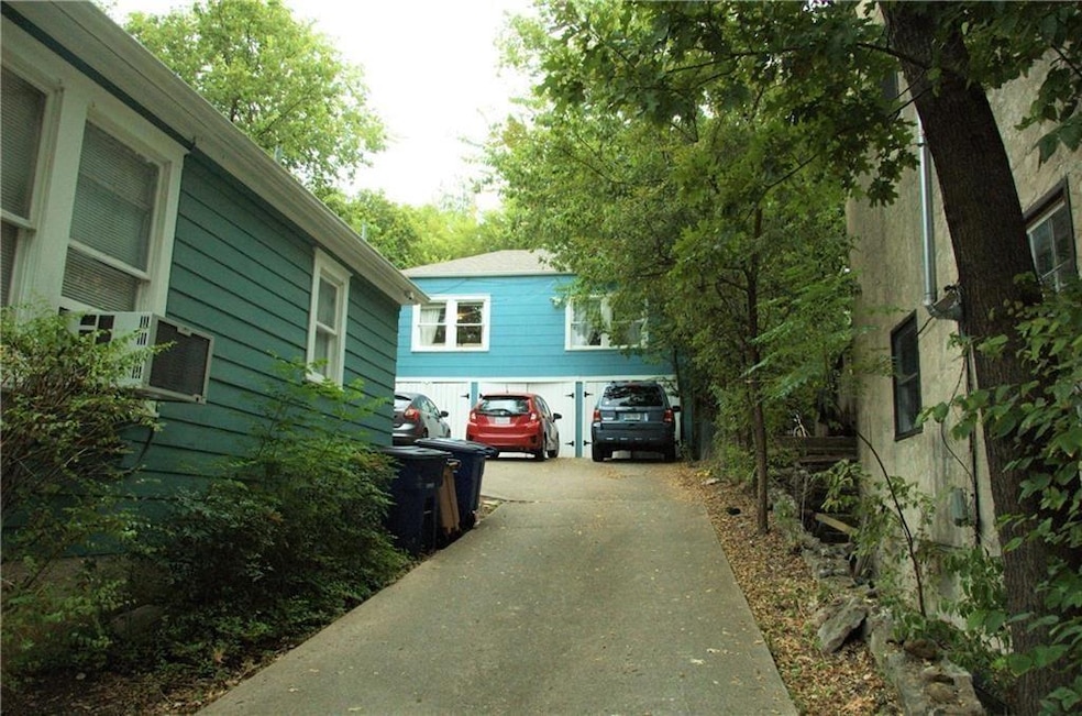 View of side of home with asphalt driveway and co