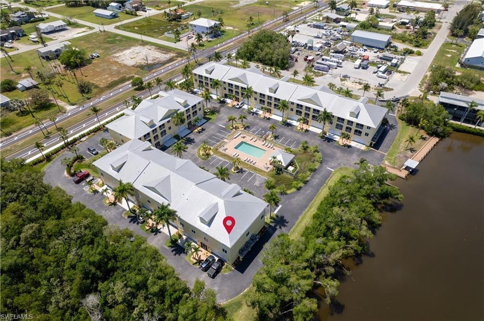 Birds eye view of property with a water view