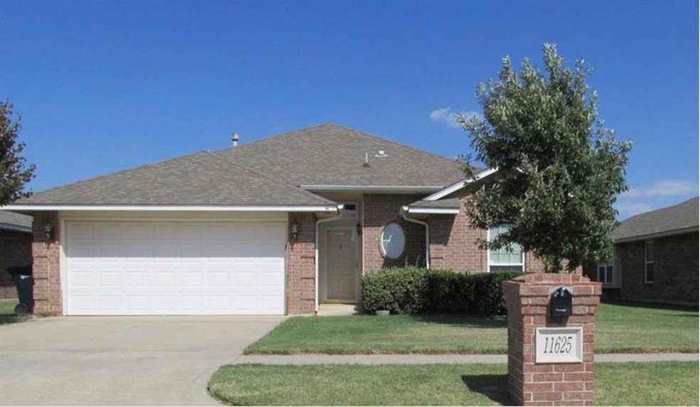 Single story home with a front yard and a garage