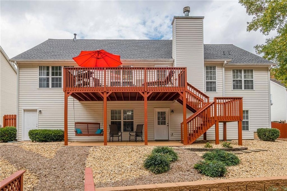 Rear view of property with a patio and a deck