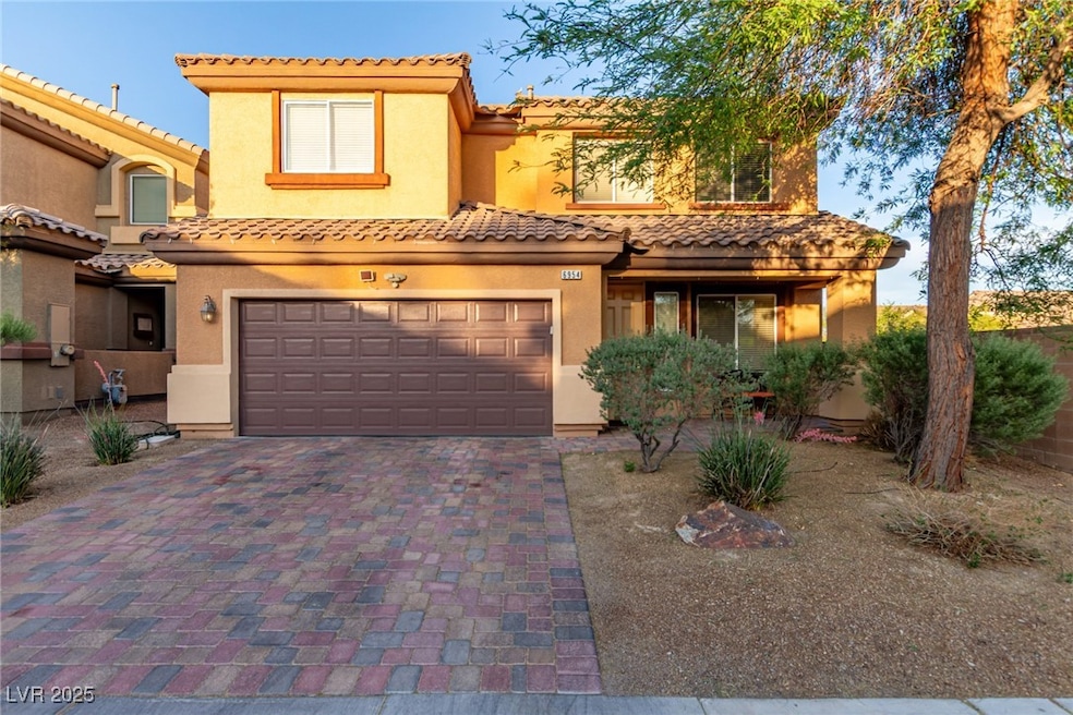 View of front facade with a garage, stucco siding,