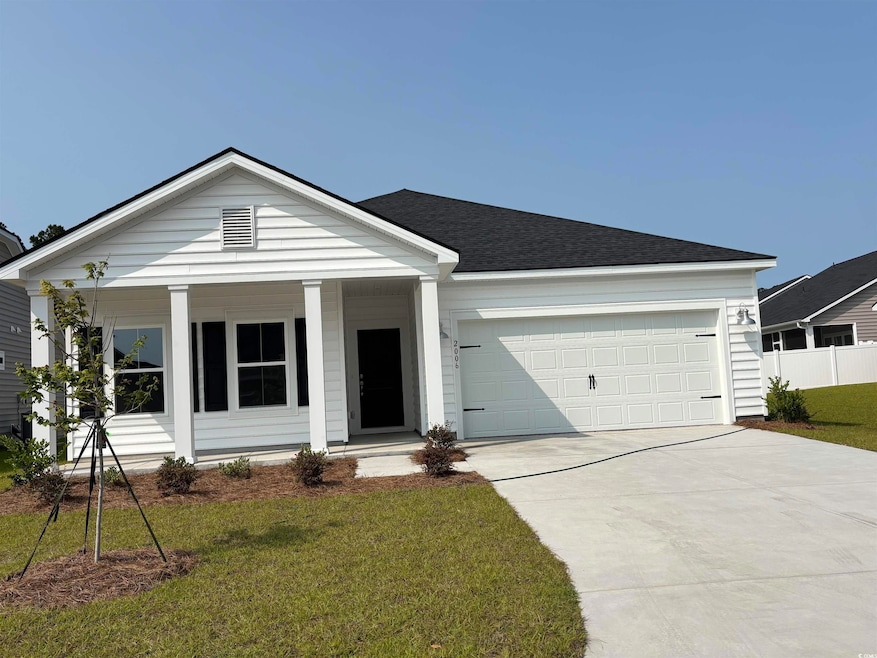 View of front of home featuring a porch, driveway, a garage, and roof with shingles