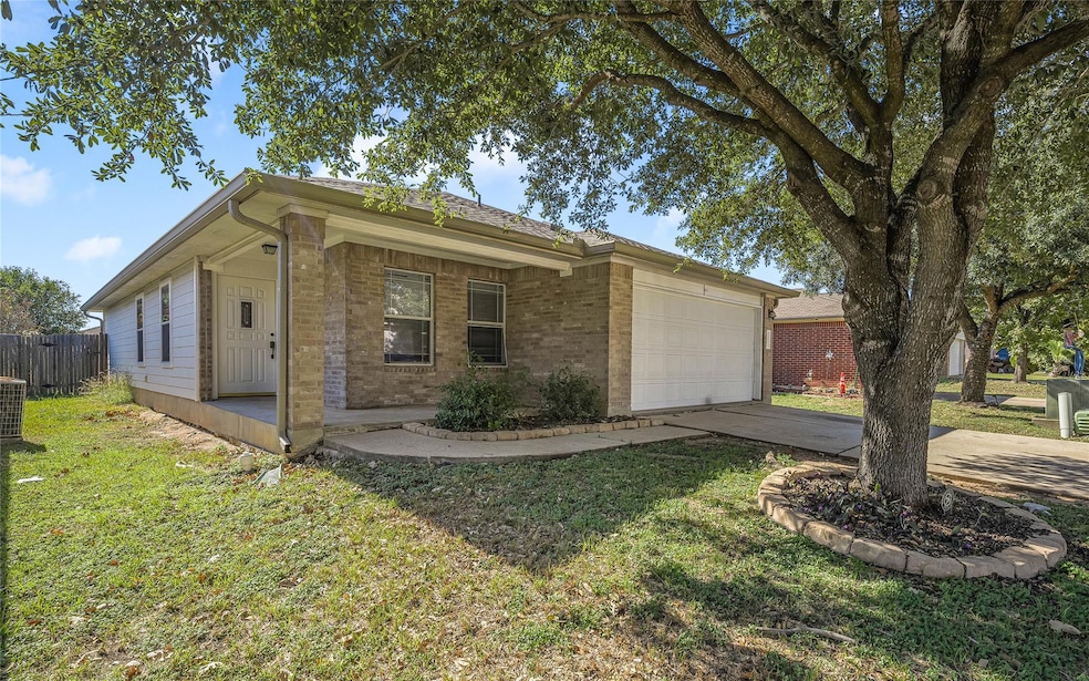 Ranch-style house with concrete driveway, brick siding, and an attached garage