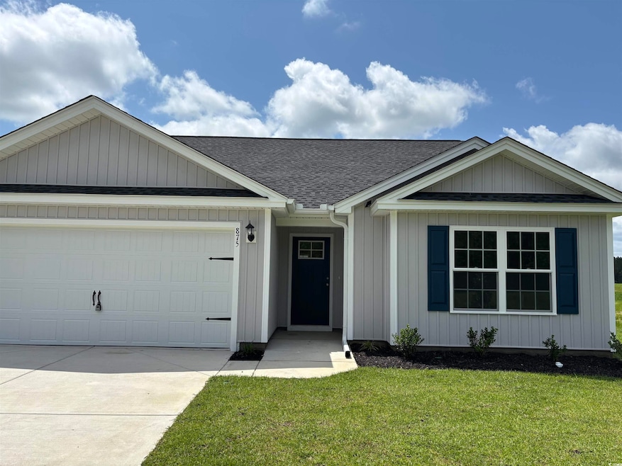 View of front of home with a shingled roof, a front lawn, an attached garage, and concrete driveway