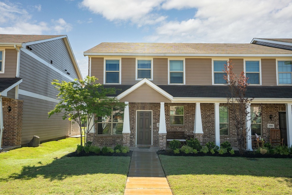 View of front of house with brick siding and a front yard