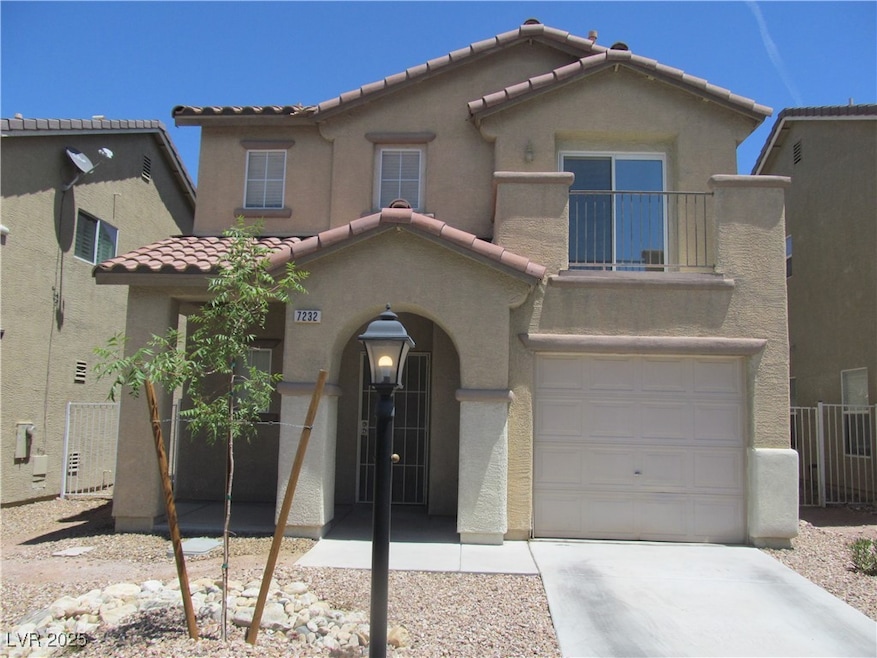 View of front of home with a tiled roof, a garage,