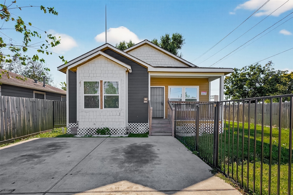 Welcoming front entry with fenced yard and private driveway