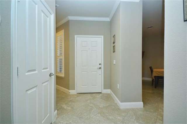 Crown molding and plantation shutters welcome you inside this delightful home.