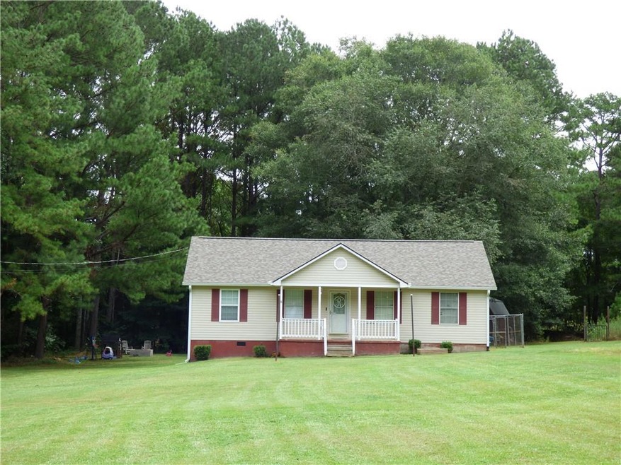 Ranch-style home featuring a porch and a front yar