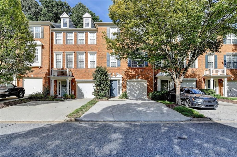 Colonial-style house featuring brick siding and driveway