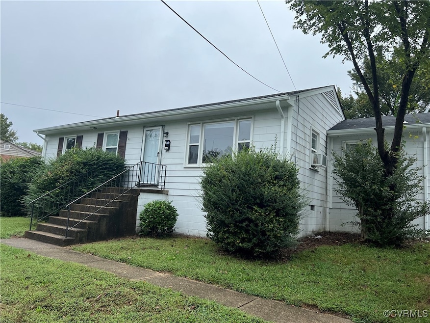 View of front of property featuring cooling unit and a front lawn