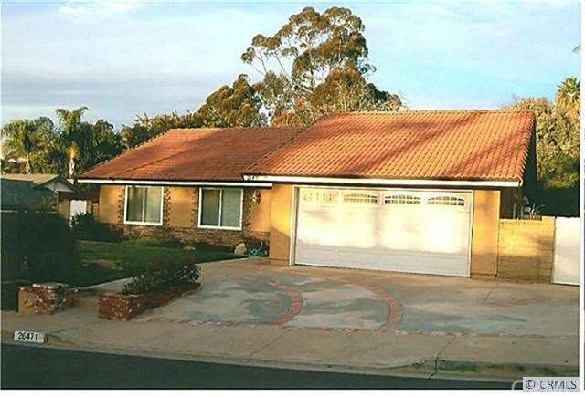 Beautifully landscaped front yard with brick accen