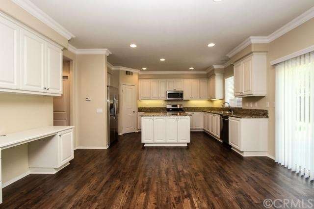 Kitchen with granite slab counters and stainless s