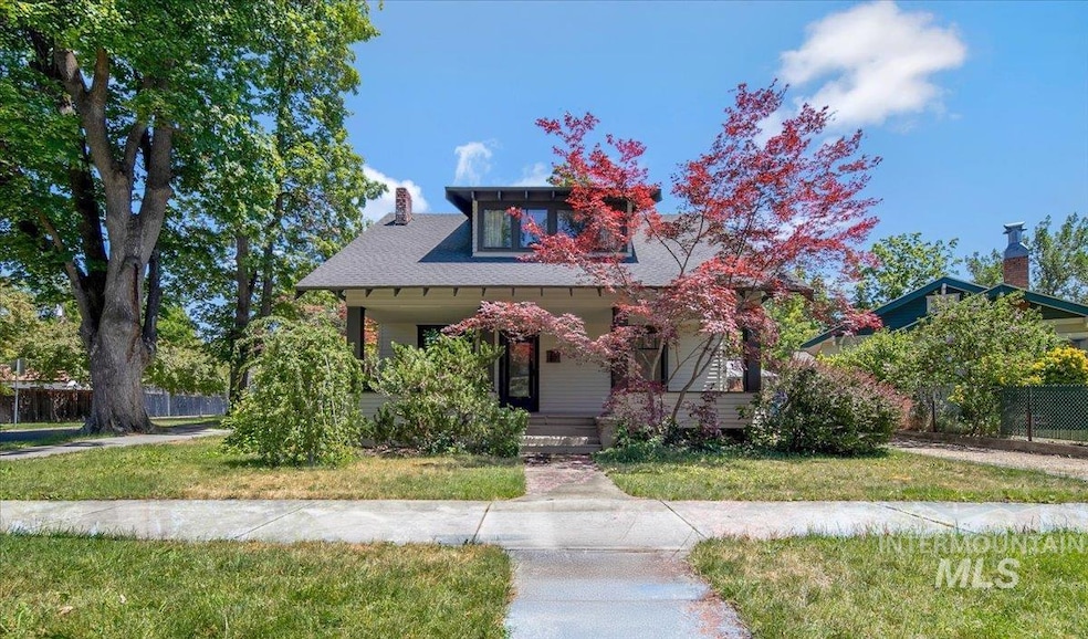 View of front of home featuring a porch and a chimney