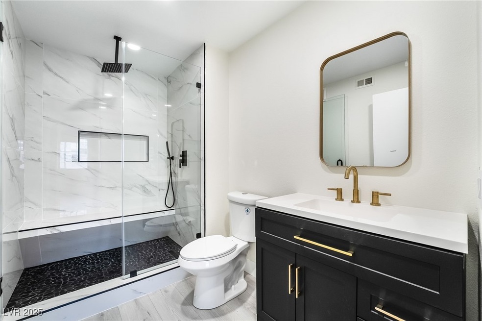 Full bathroom with a marble finish shower, visible