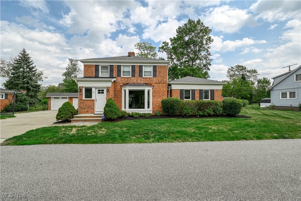 View of front of house featuring brick siding and a garage